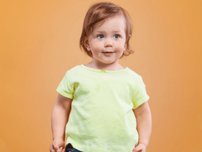 Menino loiro de olhos claros vestindo camiseta amarela e calça jeans Menino loiro de olhos claros vestindo camiseta amarela e calça jeans